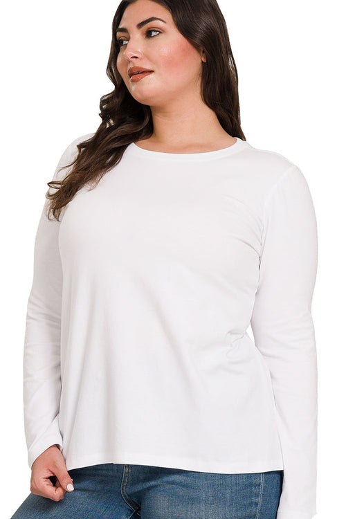 Woman wearing a white long-sleeve top and blue jeans on a white background