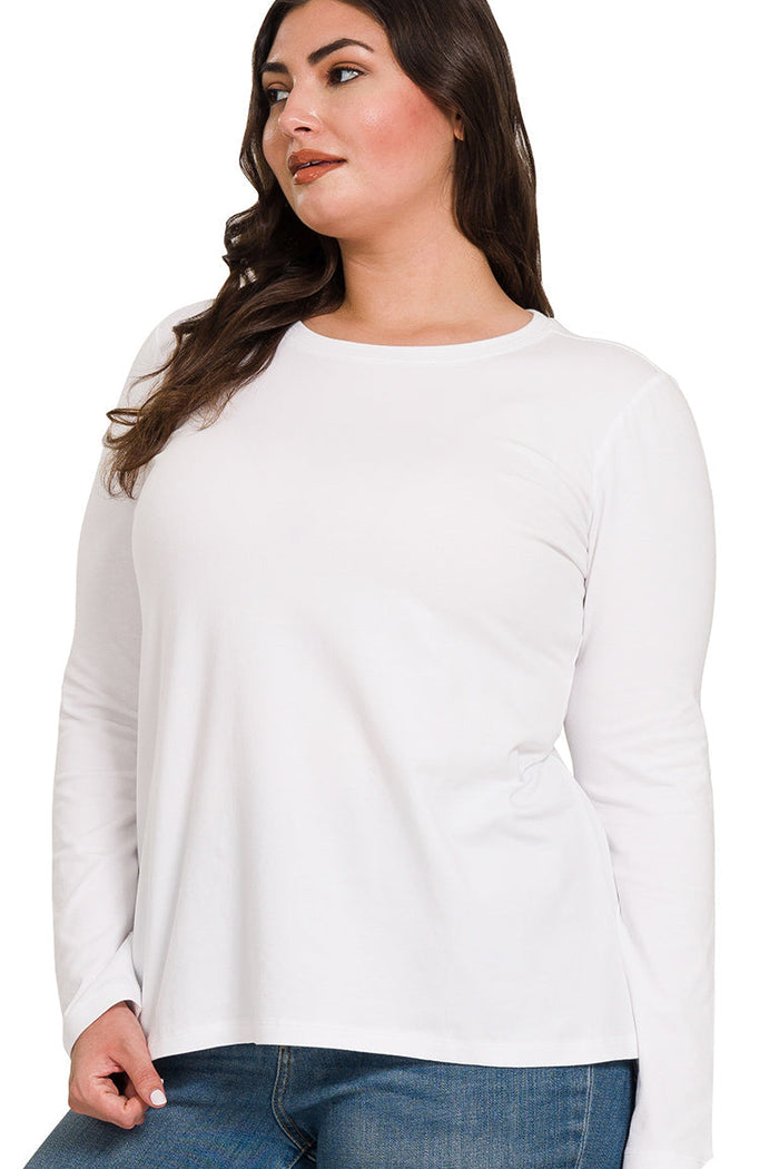 Woman wearing a white long-sleeve top and blue jeans on a white background
