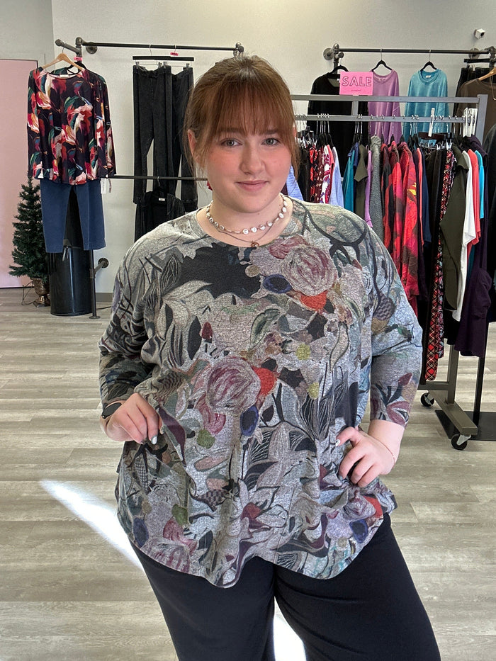 Woman wearing a floral blouse in a clothing store